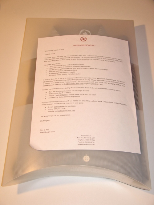 The shirt arrives in this translucent package with a note on Alexander West stationery describing details of the shirt, what to do if it does not fit properly ("we can make minor adjustments free of charge"), and instructions for care. The letter opens: "Enclosed, please find your first Alexander West shirt per your specific designs and the body measurements you provided. All shirts are individualized to your unique body contour and they are distinguished by their classic long tail design as well as their beautiful mother of pearl buttons. 